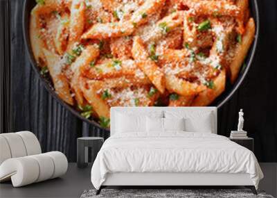 Tasty traditional pasta alla vodka topped with parmesan and parsley close-up in a plate. Vertical top view Wall mural