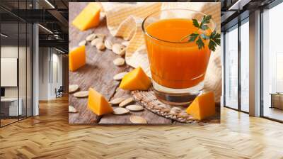 the useful juice of ripe pumpkin close-up on the table Wall mural