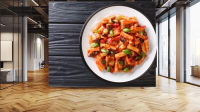 Tortiglioni pasta diet recipe with summer vegetables and basil in tomato sauce close-up in a plate. Horizontal top view Wall mural