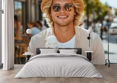 A blonde man enjoying a scoop of creamy ice cream at a trendy outdoor café. Wall mural