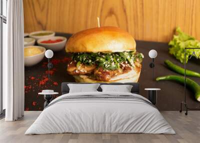 Brioche Chicken teriyaki Burger with tomato sauce and green chilli isolated on table side view of fastfood Wall mural