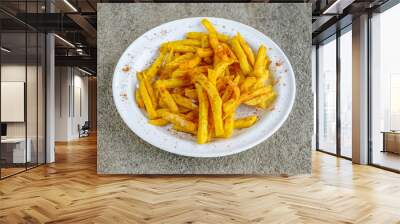 Masala French fries served in dish isolated on grey background side view of indian spices and pakistani food Wall mural