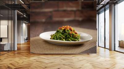 Sauteed Kang Kong with Sambal served in a dish isolated on mat side view on dark background Wall mural