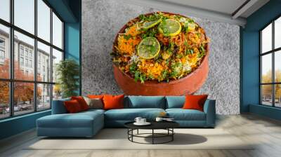 Spicy chilman, matka or clay chicken biryani pot topping with lime slice and oriander served in dish isolated on grey background side view of indian spices and pakistani food Wall mural