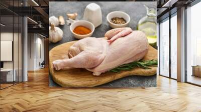 half raw chicken, ingredients for cooking, garlic, vegetables on wooden rustic board, uncooked chick Wall mural