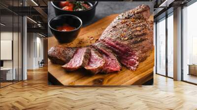 Juicy Beef rump steak from marble beef medium rare with sauce on wooden board, close-up. Selective focus. Wall mural