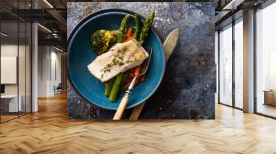 Pike perch fillet with asparagus, broccoli and carrots. Fried fish with stewed greens Wall mural