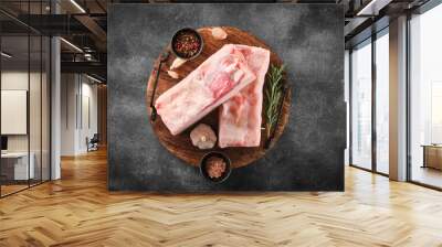 Two pieces of raw pork lard with spices on wooden board, top view Wall mural