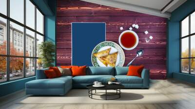 Plate with delicious samosas or samsa with tea on wooden background. Top view there is a place for text Wall mural