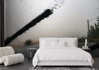 Heavy rain. Cloudburst on windshield. Windscreen wiper and bad visibility. Wall mural