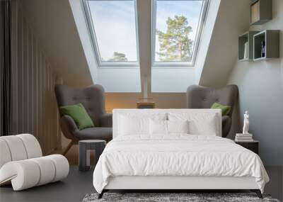 Modern retro design in a attic / loft. Small vintage table with a radio on and two reading chairs under two skylights. Wall mural