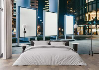 3 blank white posters empty white billboards mockup standing in front of an office building at night, with a city background at night time. commercial photo Wall mural