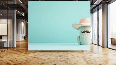 A quirky cactus with a playful mustache and a sombrero is styled against a teal background, creating a fun and whimsical scene that adds character and charm to the image, photo Wall mural