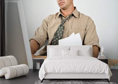 Tired Young Man at Desk Paying Bills Wall mural