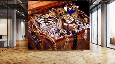 Old wooden open chest with golden jewelry Wall mural