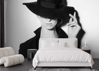 high fashion portrait of elegant woman in black and white hat and dress. Studio shot Wall mural