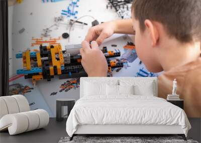 A little boy plays with blocks. Educational fun for children. Wall mural