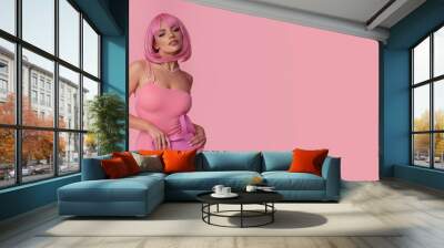 Beautiful young woman with pink hair in a fashionable styling. Wall mural