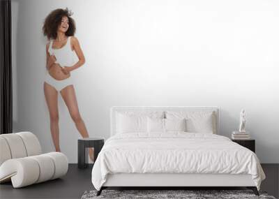 Fantastic afroamerican girl with tiny body posing in white underwear. Wall mural