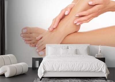 Female hands and feet on white background. Studio shoot. Wall mural