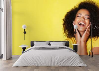 Super happy afro-american girl isolated on yellow background. Wall mural