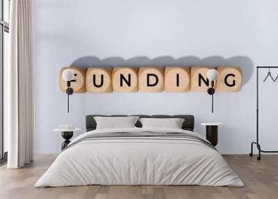 Funding word on wooden block isolated on gray background Wall mural