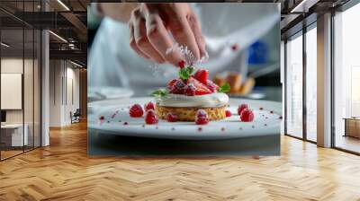 A chef sprinkles powdered sugar on a dessert with strawberries Wall mural