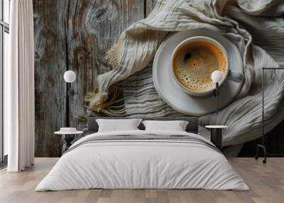 A white coffee cup with a brown liquid in it sits on a wooden table Wall mural