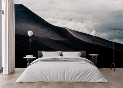 Minimal dark wallpaper. Black mountain with grey clouds, sand dunes, sombre, moody 4k background. Wall mural