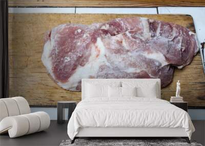 Frozen piece of meat on a wooden cutting board Wall mural