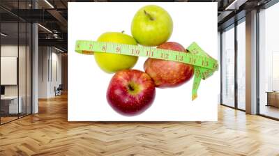 Two green apples, two read apples and measuring tape isolated on white. Wall mural