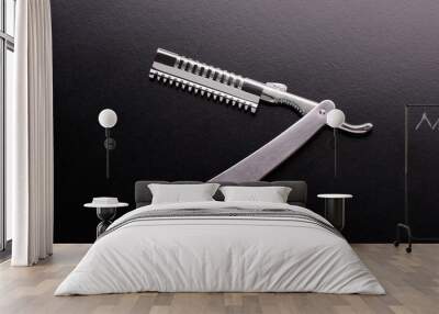 Steel razor close-up. Straight razor. Razor on a black background. Barber tool. Wall mural