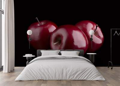 Three ripe dark red apples on a black background Wall mural