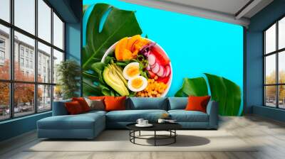 buddha bowl served on monstera leaves Wall mural