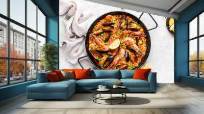 Paella in a special pan, ready to eat, view from above Wall mural