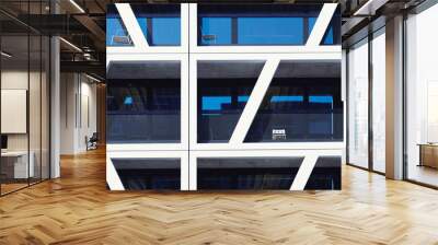 Modern apartment buildings on a sunny day. Facade of a modern apartment building with balconies. Futuristic geometric pattern. Blue windows reflection. Wall mural