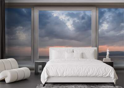 A window with the panoramic views of the sea and the beautiful sunrise Wall mural