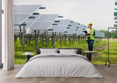 A young female solar cell engineer is working hard. Working in alternative energy Solar energy Wall mural