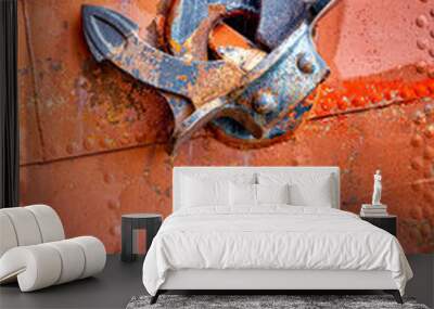 Rusty anchor on historic orange ship wall. Wall mural