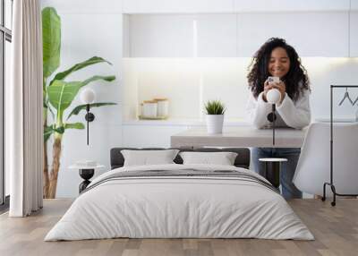 African American Girl using smartphone at home pressing finger, reading social media internet, typing text or shopping online Mobile phone in two black hands Wall mural