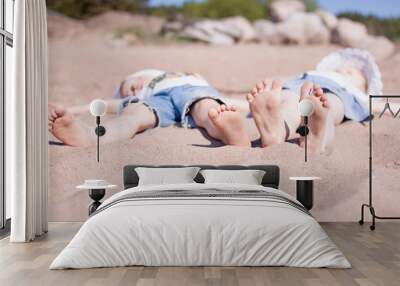 boy and girl lie on the  sand beach Wall mural