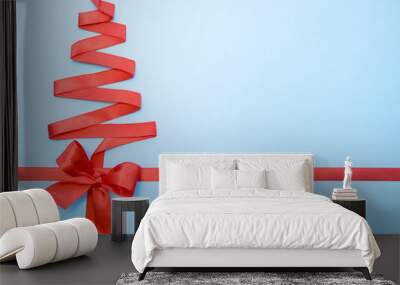 Christmas and new year tree made from red ribbon on blue background free space for text - holidays, winter and celebration concept - Wall mural