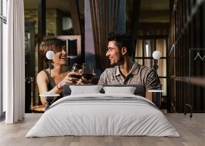 Couple in bar smiling and drinking in traditional restaurant Wall mural