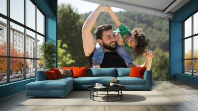 Father and baby girl playing outdoors Wall mural