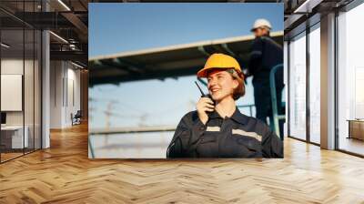 Electrician engineer women working on checking and maintenance equipment at industry solar power. Wall mural