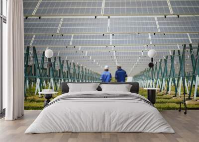 Engineer and Female Apprentice Working Together On Solar Farm Installation. Wall mural