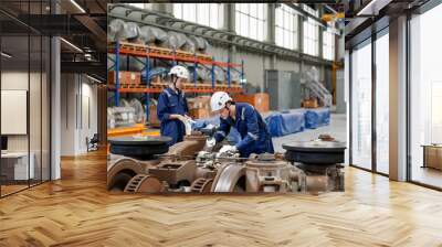 Engineers inspecting locomotive in railway engineering facility Wall mural