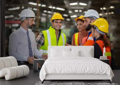 Group of Industrial Engineers Talk with Factory Worker. They Work at the Heavy Industry Manufacturing Facility. Wall mural