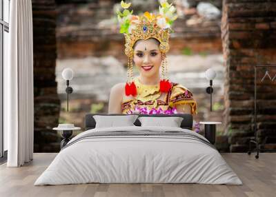 Portrait of an Balinese dancer is holding oblation after prayer in Traditional Attire at Bali Gate Wall mural