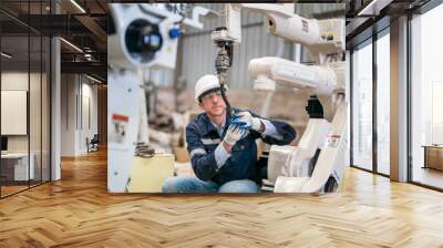 Robotics engineer fitting sensors to traditional engineering lathe in robotics research facility Wall mural